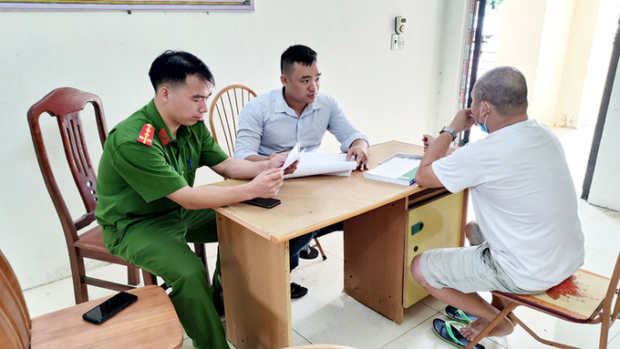 Công an huyện Lục Ngạn làm việc với ông T.V.Q (bên phải).