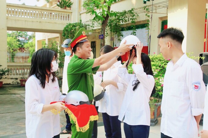 Học sinh hào hứng học cách đội mũ bảo hiểm đúng quy cách